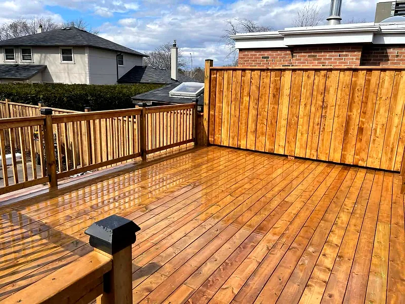 A large cedar deck with a privacy wall and cedar railings